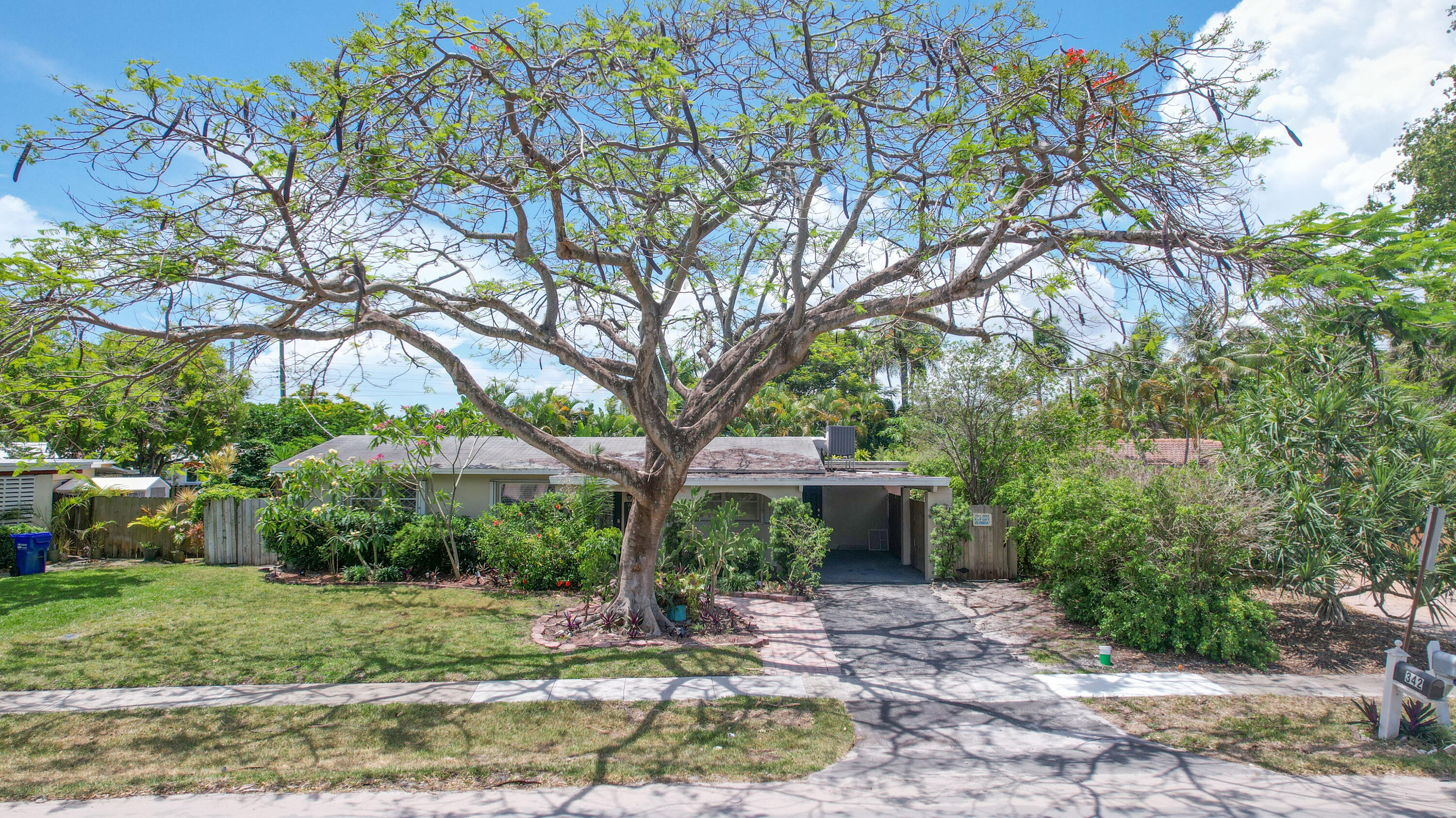 342 Southwest 14th Street Pompano Beach, FL 33060 - Photo 2 of 39 a front view of a house with garden
