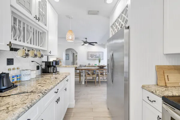 a kitchen with granite countertop a sink appliances and cabinets