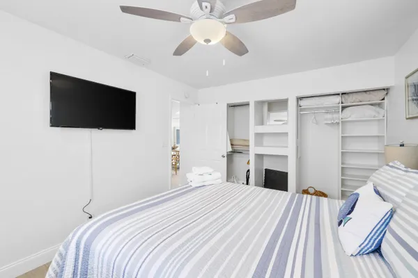 a bedroom with a bed and a flat screen tv
