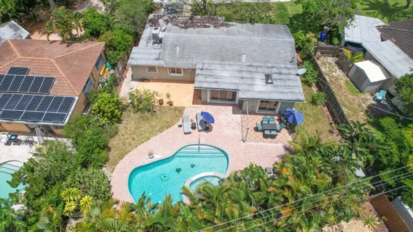 an aerial view of a house with a yard and potted plants