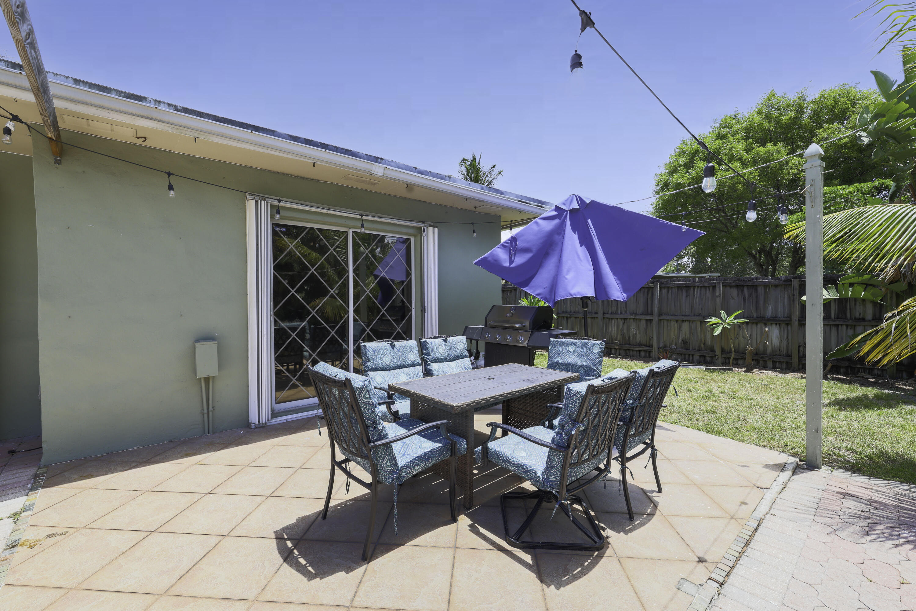 342 Southwest 14th Street Pompano Beach, FL 33060 - Photo 33 of 39 a view of a patio with a table and chairs under an umbrella