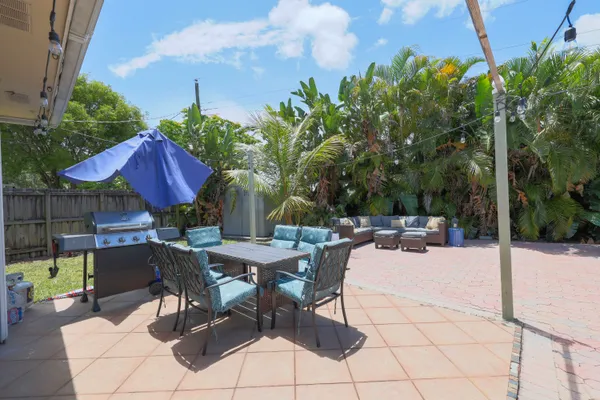 a view of backyard with sitting area