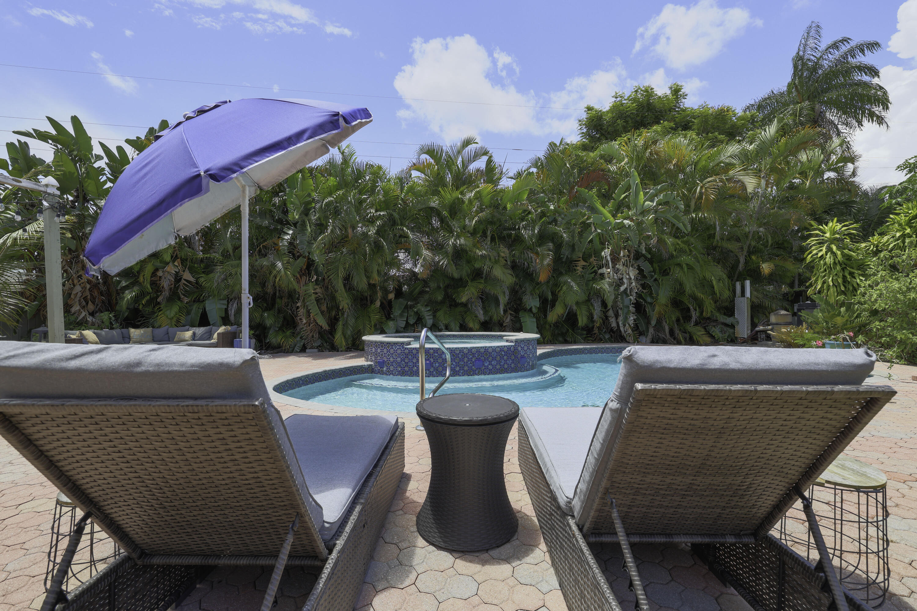 342 Southwest 14th Street Pompano Beach, FL 33060 - Photo 38 of 39 a view of a patio with table and chairs potted plants with wooden floor and fence