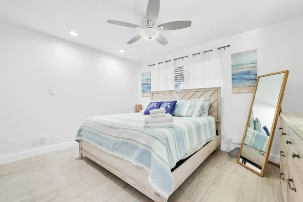 a bed room with a bed and a flat tv screen