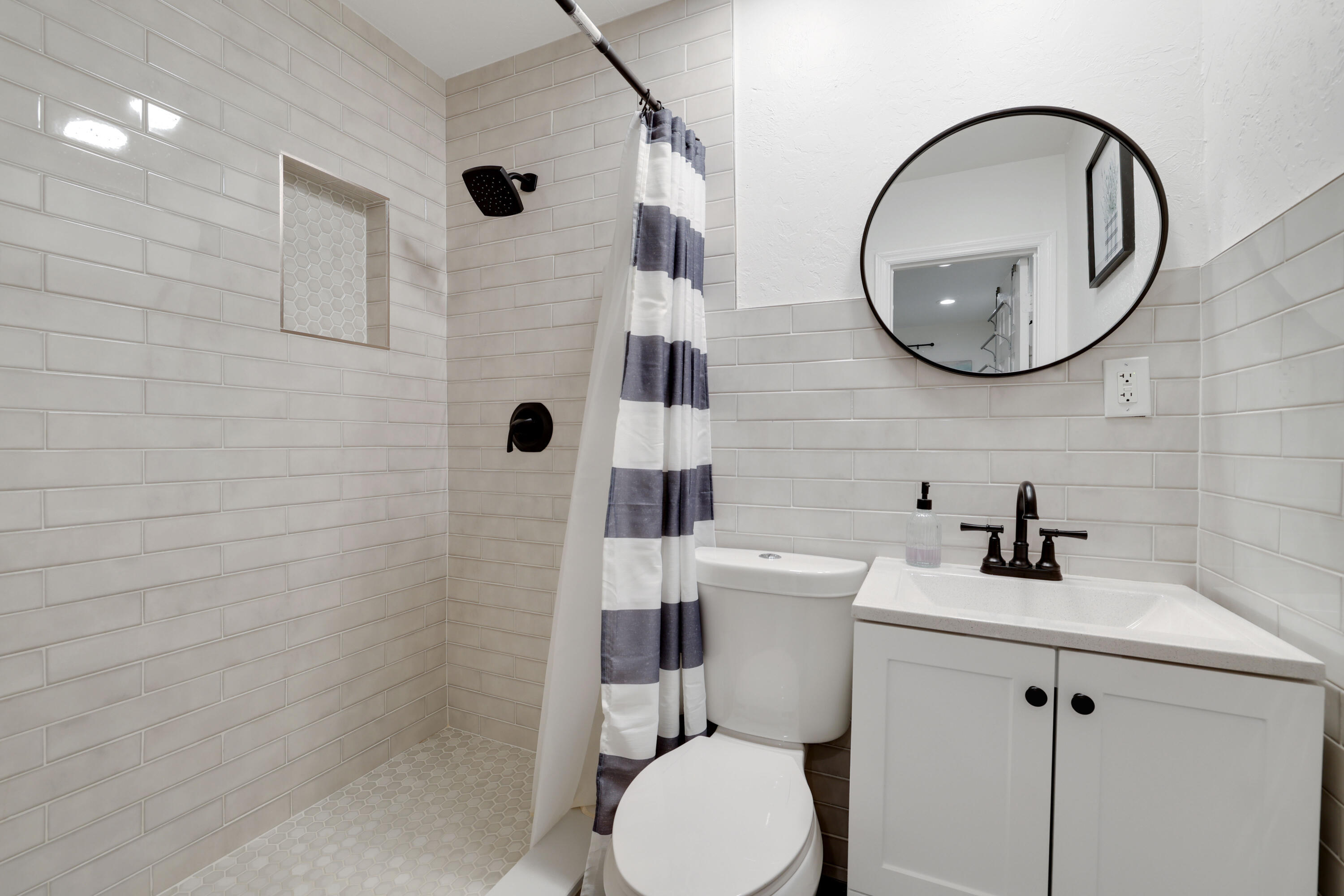 342 Southwest 14th Street Pompano Beach, FL 33060 - Photo 10 of 39 a bathroom with a toilet a sink and mirror