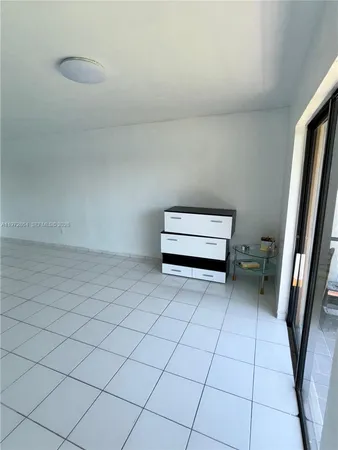 a view of a room with wooden floor and bench