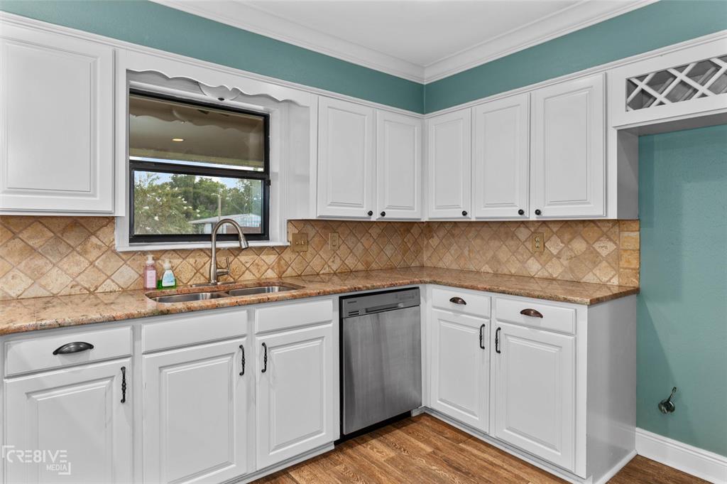 6095 Keithville-Springridge Road Keithville, LA 71047 - Photo 11 of 38 a kitchen with granite countertop white cabinets white stainless steel appliances and a sink