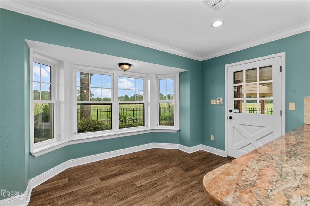 6095 Keithville-Springridge Road Keithville, LA 71047 - Photo 13 of 38 a view of a bedroom with wooden floor and a window