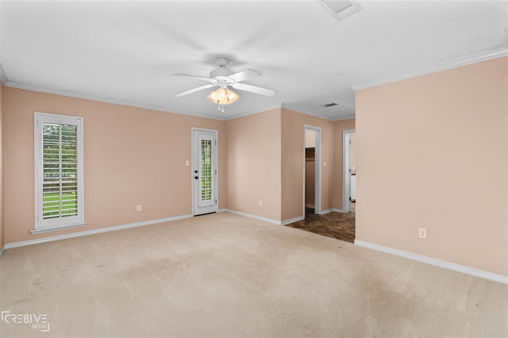 6095 Keithville-Springridge Road Keithville, LA 71047 - Photo 16 of 38 an empty room with windows and chandelier fan