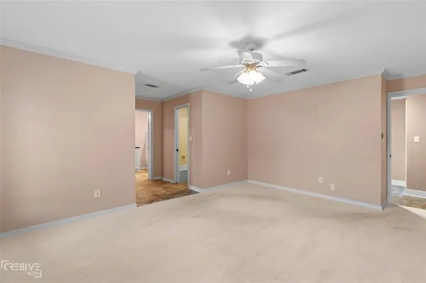 a view of an empty room with a ceiling fan