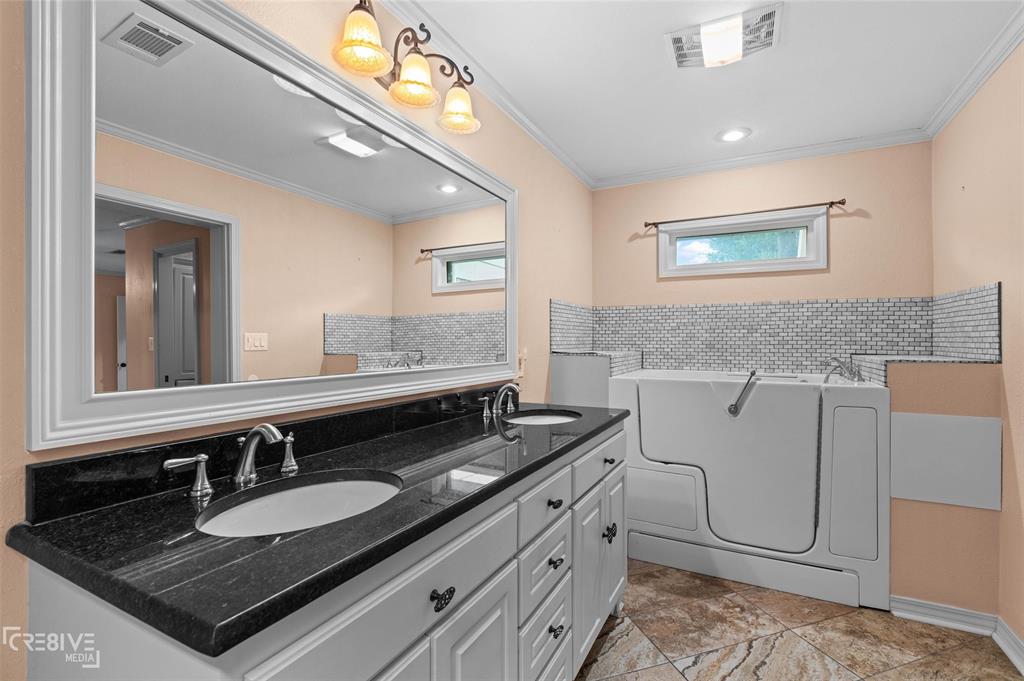 6095 Keithville-Springridge Road Keithville, LA 71047 - Photo 19 of 38 a bathroom with a granite countertop sink and a mirror