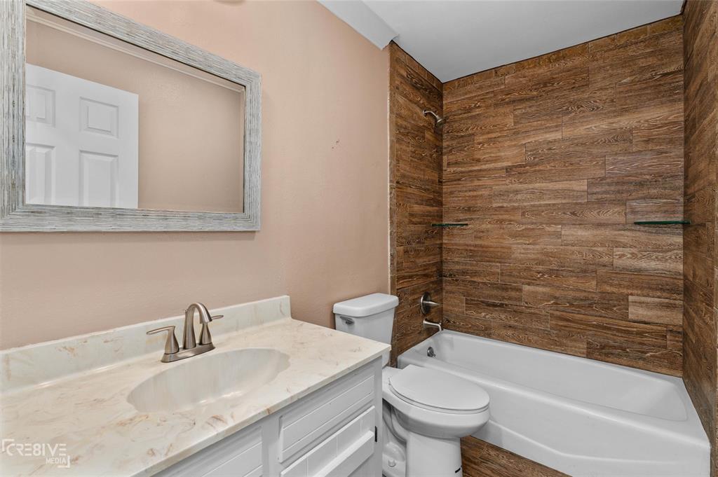 6095 Keithville-Springridge Road Keithville, LA 71047 - Photo 23 of 38 a bathroom with a granite countertop sink toilet and shower