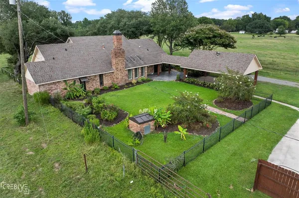 an aerial view of a house with garden space and street view