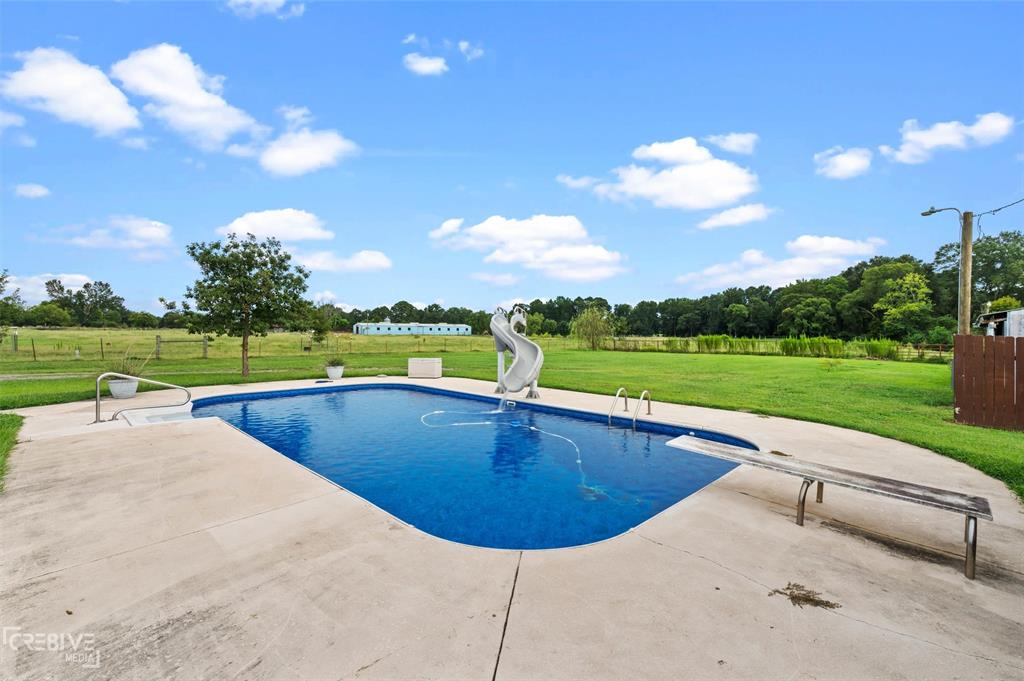 6095 Keithville-Springridge Road Keithville, LA 71047 - Photo 29 of 38 a view of a swimming pool and a yard