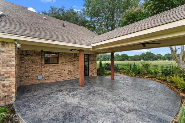 a view of a patio with a table and chairs under an umbrella