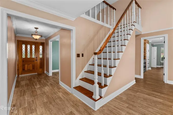 a view of entryway with wooden floor and stairs