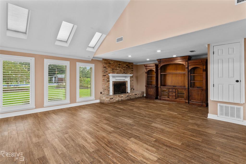 6095 Keithville-Springridge Road Keithville, LA 71047 - Photo 6 of 38 an empty room with wooden floor and fireplace