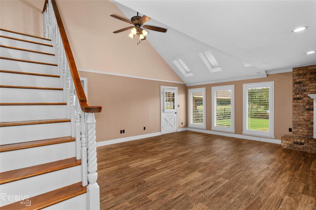 6095 Keithville-Springridge Road Keithville, LA 71047 - Photo 7 of 38 a view of an empty room with wooden floor and fan