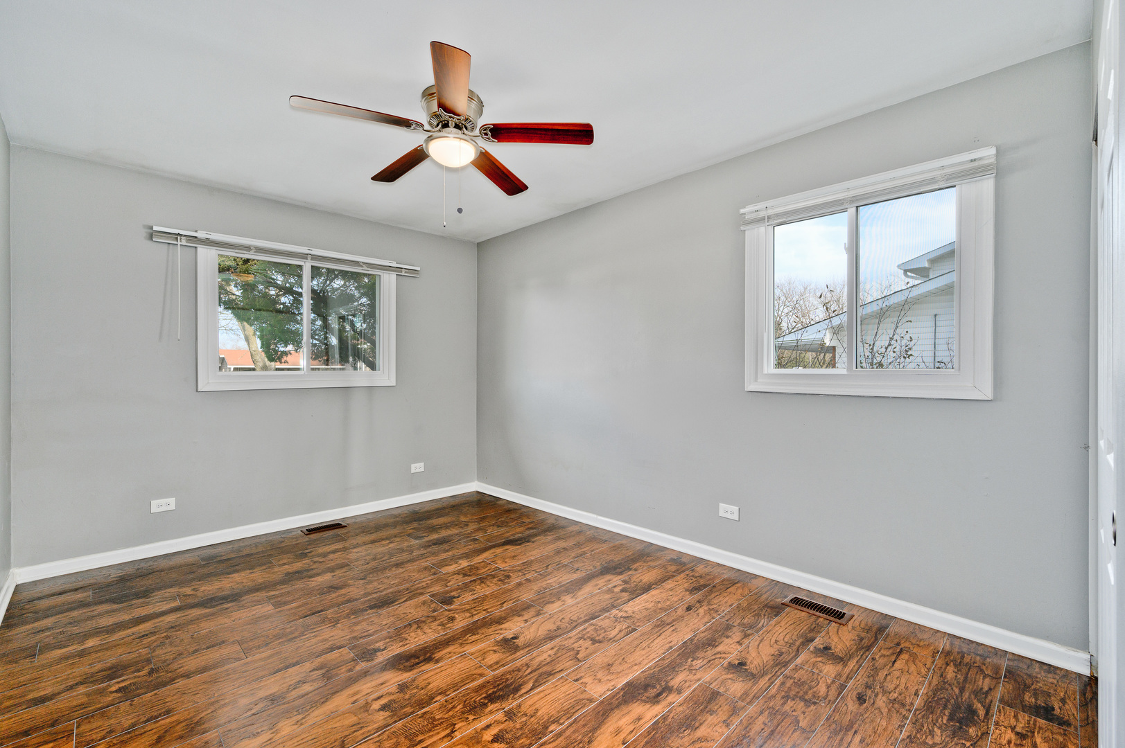 555 Jamison Lane Hoffman Estates, IL 60169 - Photo 11 of 16 a view of an empty room with wooden floor and a window