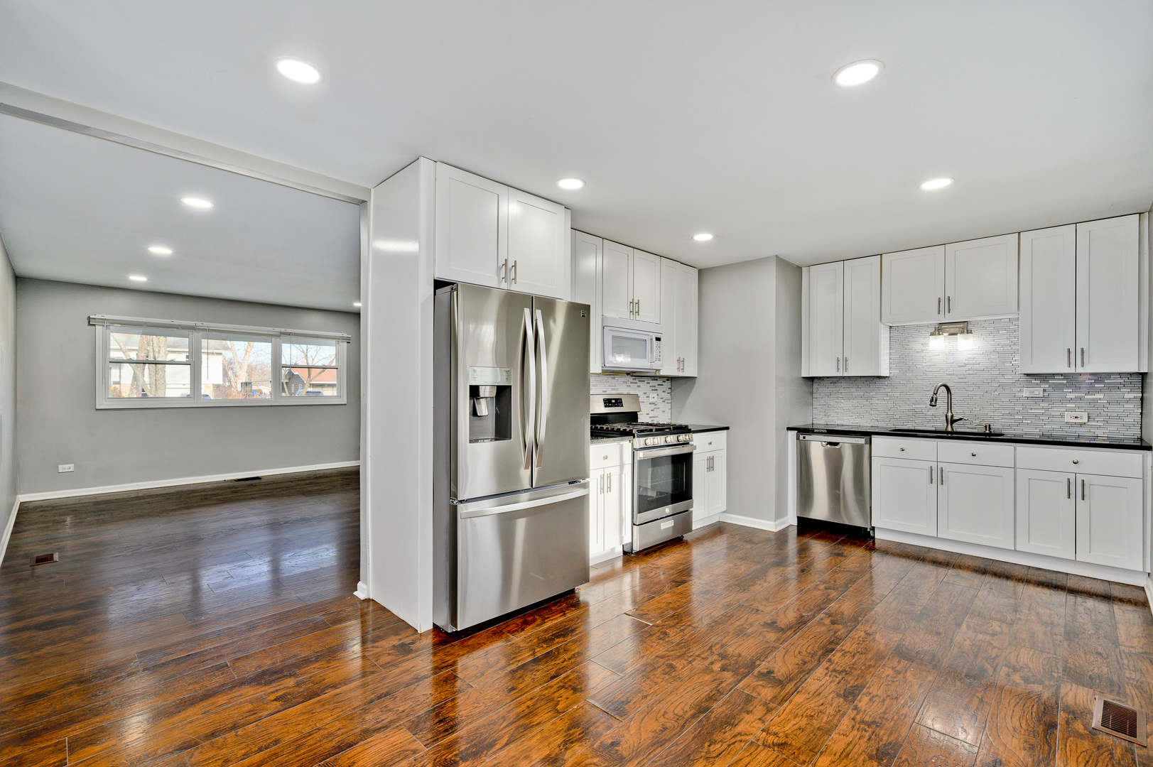 555 Jamison Lane Hoffman Estates, IL 60169 - Photo 5 of 16 a kitchen with granite countertop a refrigerator and a stove top oven