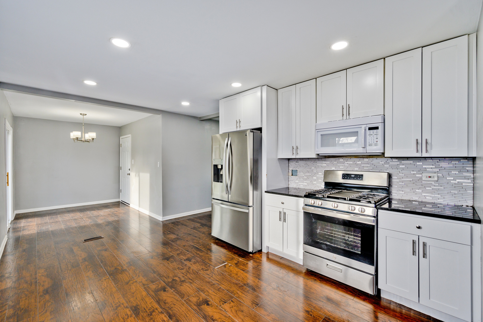 555 Jamison Lane Hoffman Estates, IL 60169 - Photo 7 of 16 a kitchen with stainless steel appliances granite countertop a refrigerator and a stove top oven