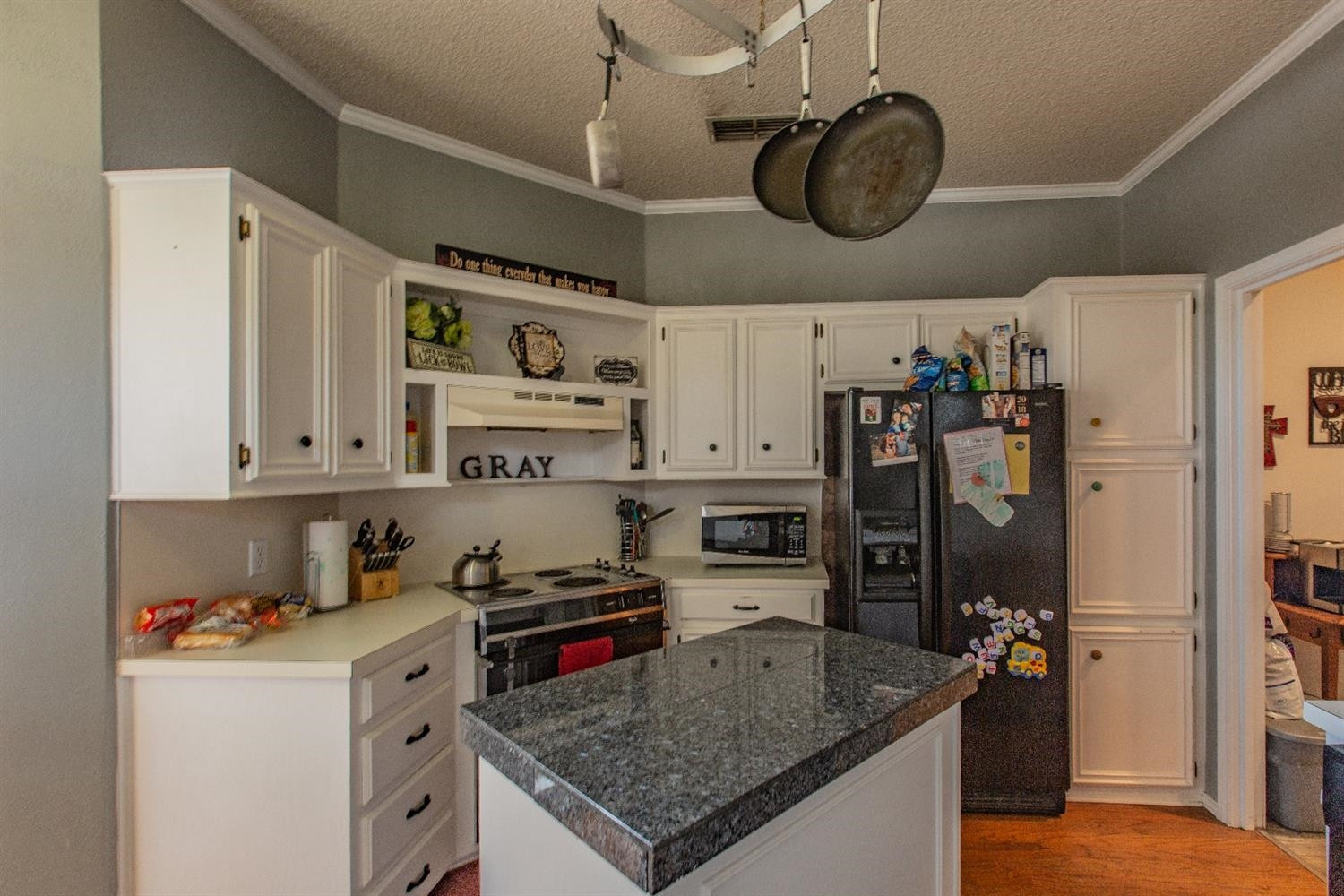 5738 94th Street Lubbock, TX 79424 - Photo 3 of 10 a kitchen with stainless steel appliances granite countertop a sink stove and refrigerator