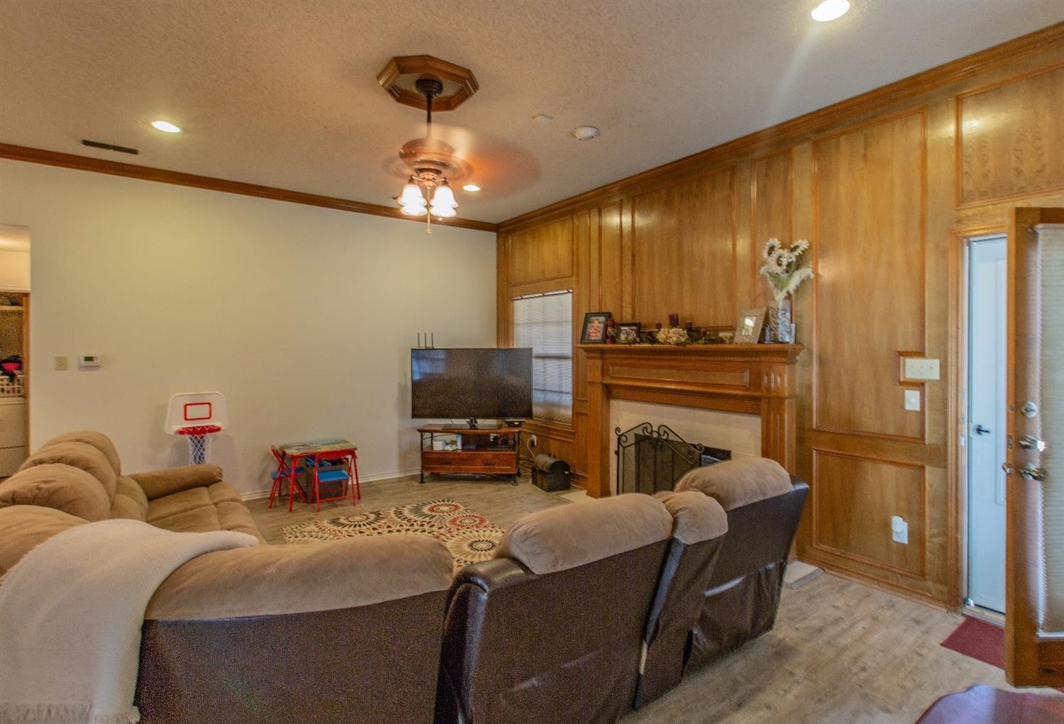 5738 94th Street Lubbock, TX 79424 - Photo 5 of 10 a livingroom with fireplace and a chandelier