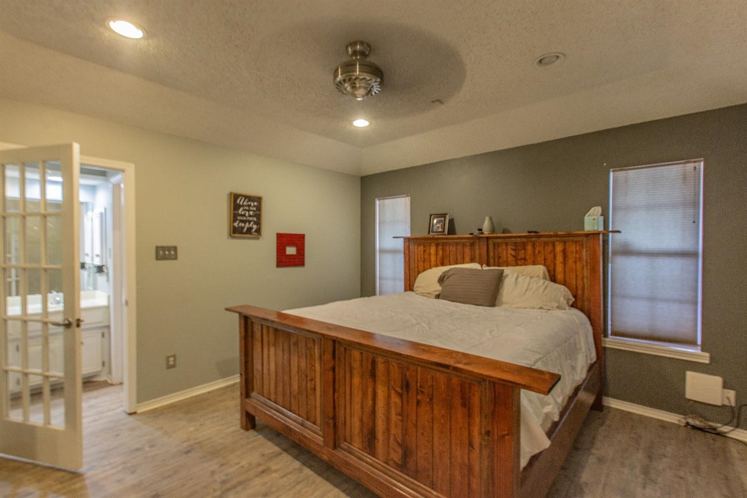5738 94th Street Lubbock, TX 79424 - Photo 8 of 10 a bedroom with a bed and a mirror