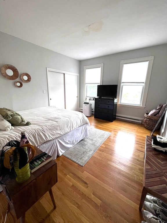 167 M Street, Unit 3F Boston, MA 02127 - Photo 5 of 7 a bedroom with a bed and wooden floor
