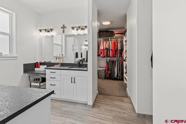 a hallway with cabinets and wooden floor