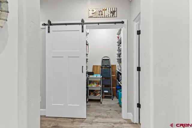 a view of a hallway with wooden shelves