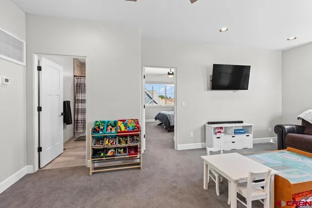 a bedroom with furniture and a flat screen tv