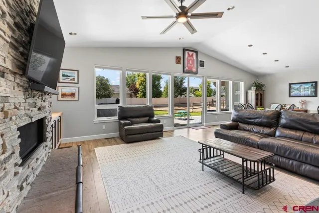 a living room with furniture a fireplace and a flat screen tv