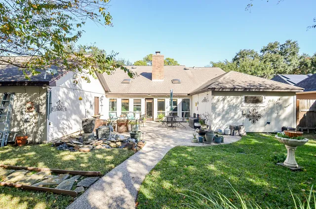 a view of backyard with outdoor seating and trees