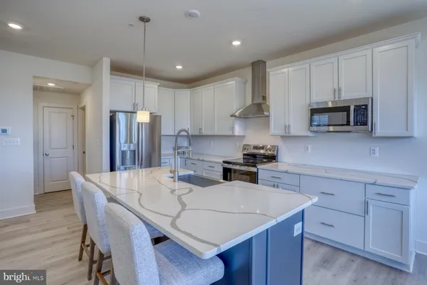 a kitchen with refrigerator cabinets and wooden floor