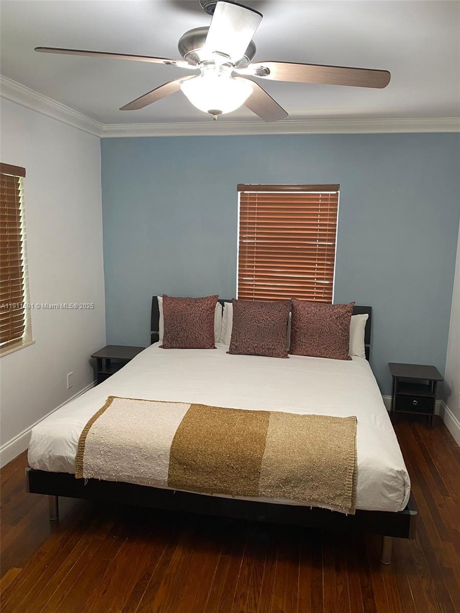 1516 Funston Street Hollywood, FL 33020 - Photo 11 of 23 a bedroom with a bed and wooden floor
