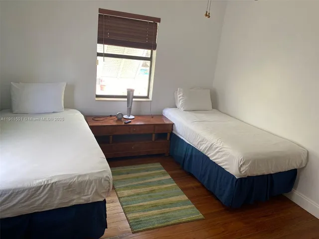 a bedroom with bed and window