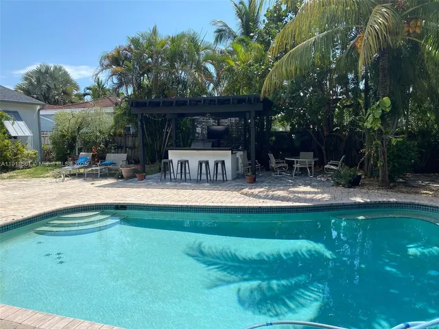 a view of swimming pool with a patio and a yard