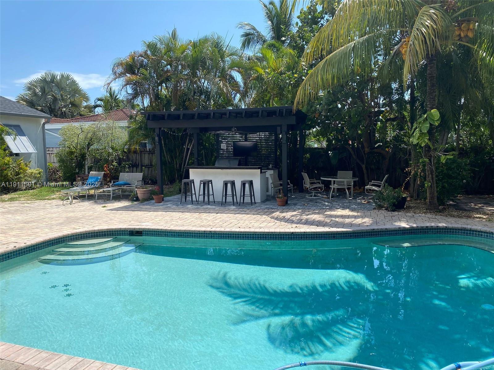1516 Funston Street Hollywood, FL 33020 - Photo 5 of 23 a view of swimming pool with a patio and a yard