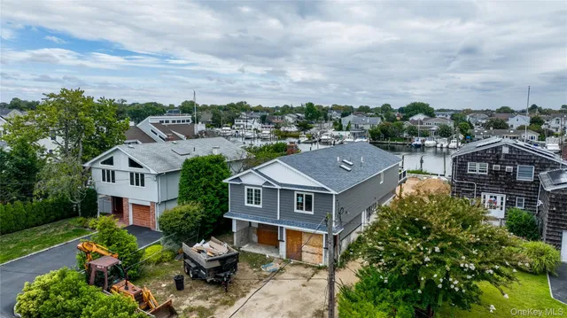 a aerial view of a house with a big yard plants and large trees