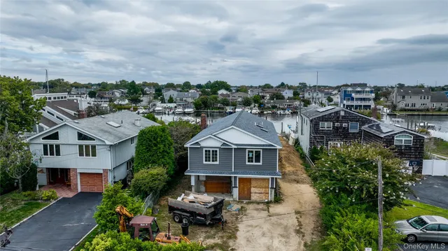 a aerial view of a house with a yard plants and large tree