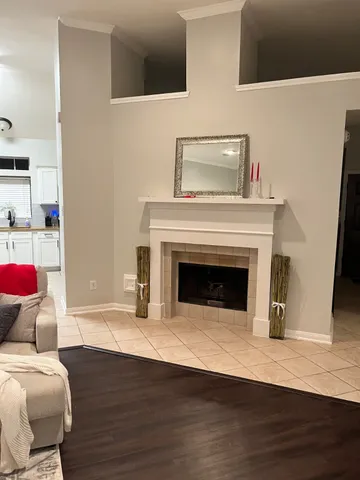 a living room with a furniture and a fireplace