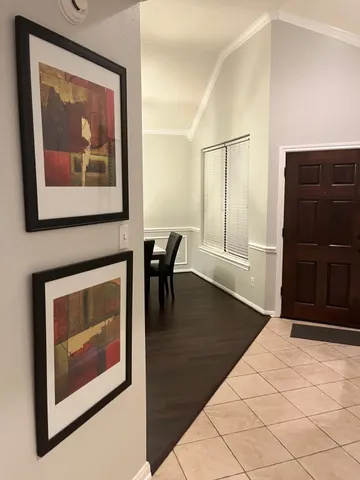 a view of a livingroom with furniture and an empty room