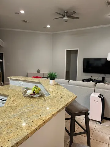 a dining room with furniture and a flat screen tv