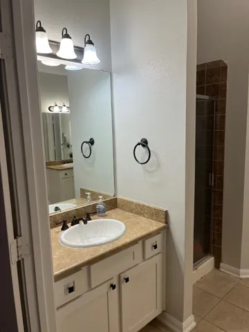 a bathroom with a sink a toilet and mirror