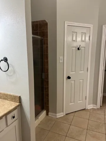 a bathroom with a shower and a mirror
