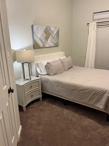 a bedroom with a bed and a mirror