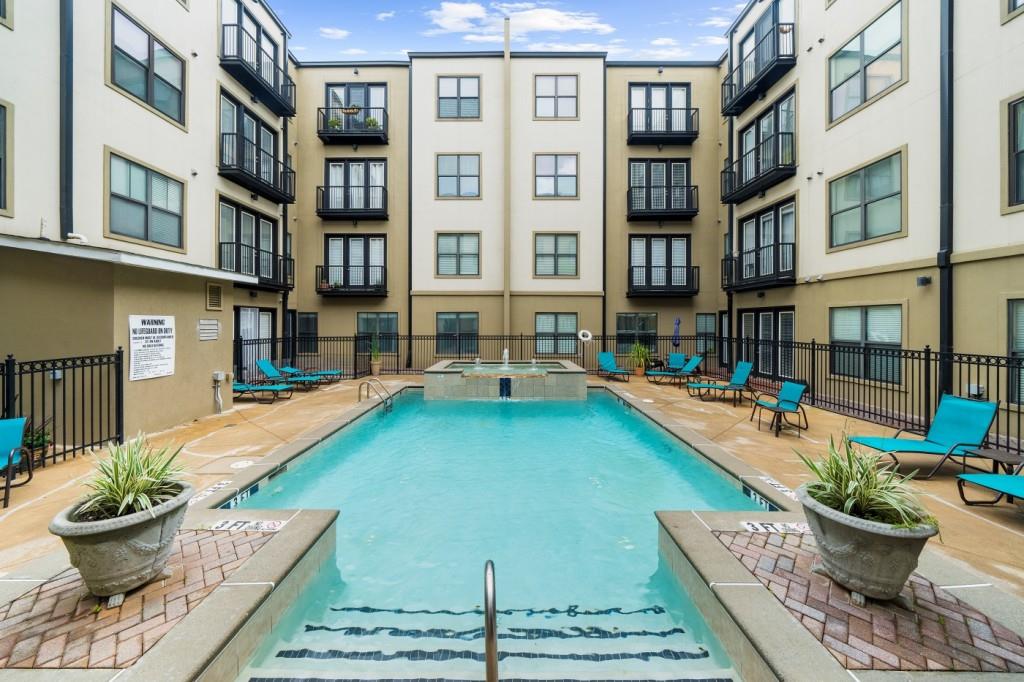 a view of a swimming pool with outdoor seating