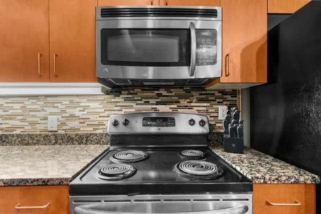 a stove top oven sitting inside of a kitchen