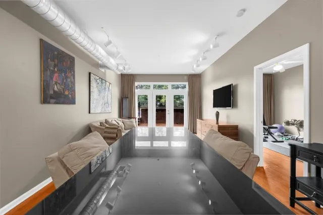 a living room with furniture large window and flat screen tv